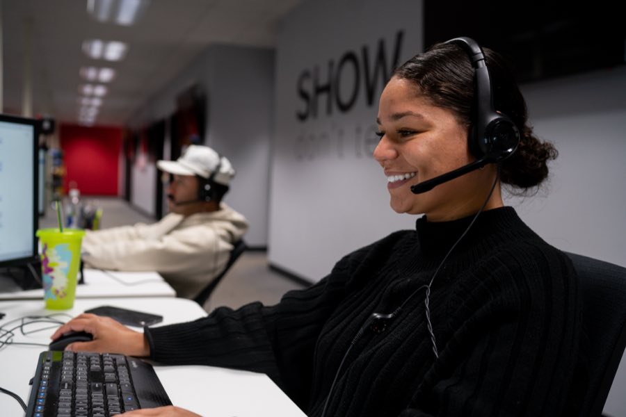 FWF rep smiling on a call at her desk