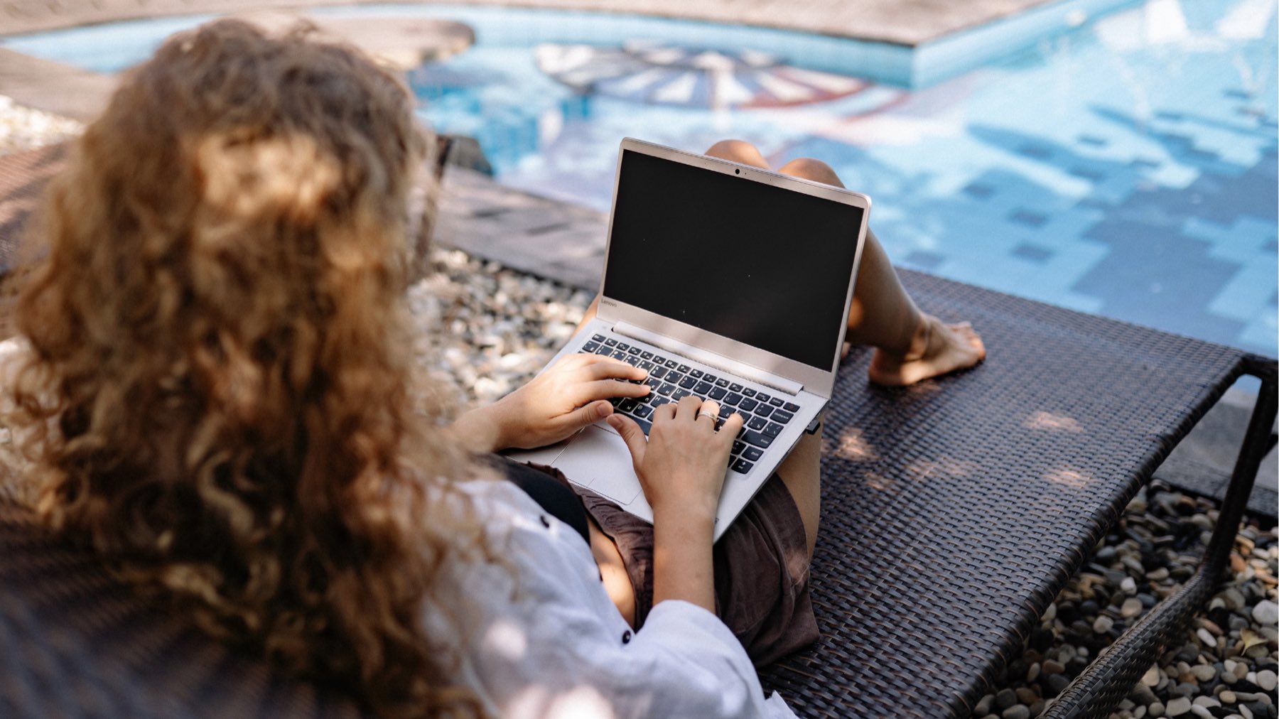 FWF agent working on a laptop by a pool